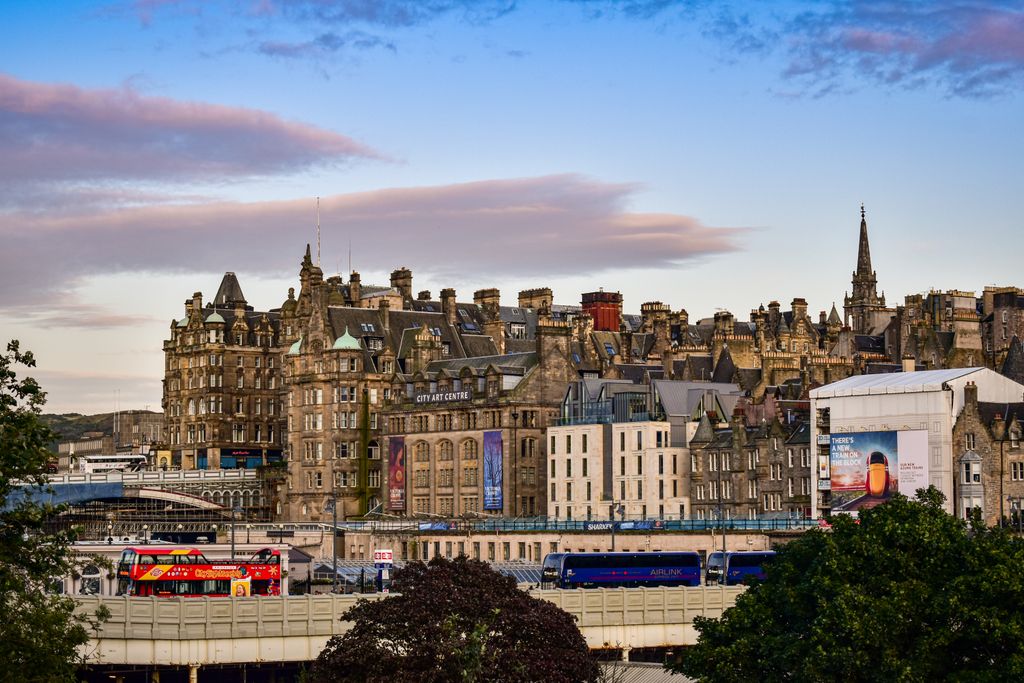 A beautiful view of Edinburgh's historic skyline at sunset, capturing City Art Centre and old buildings.