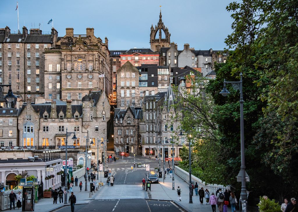 Charming view of Edinburgh's Old Town with pedestrians on a bustling street.